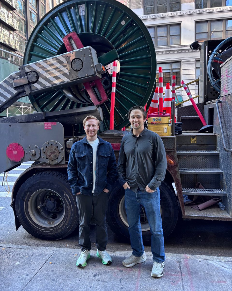 Paul Mewes and Max Meyer standing in front of a cable truck in New York